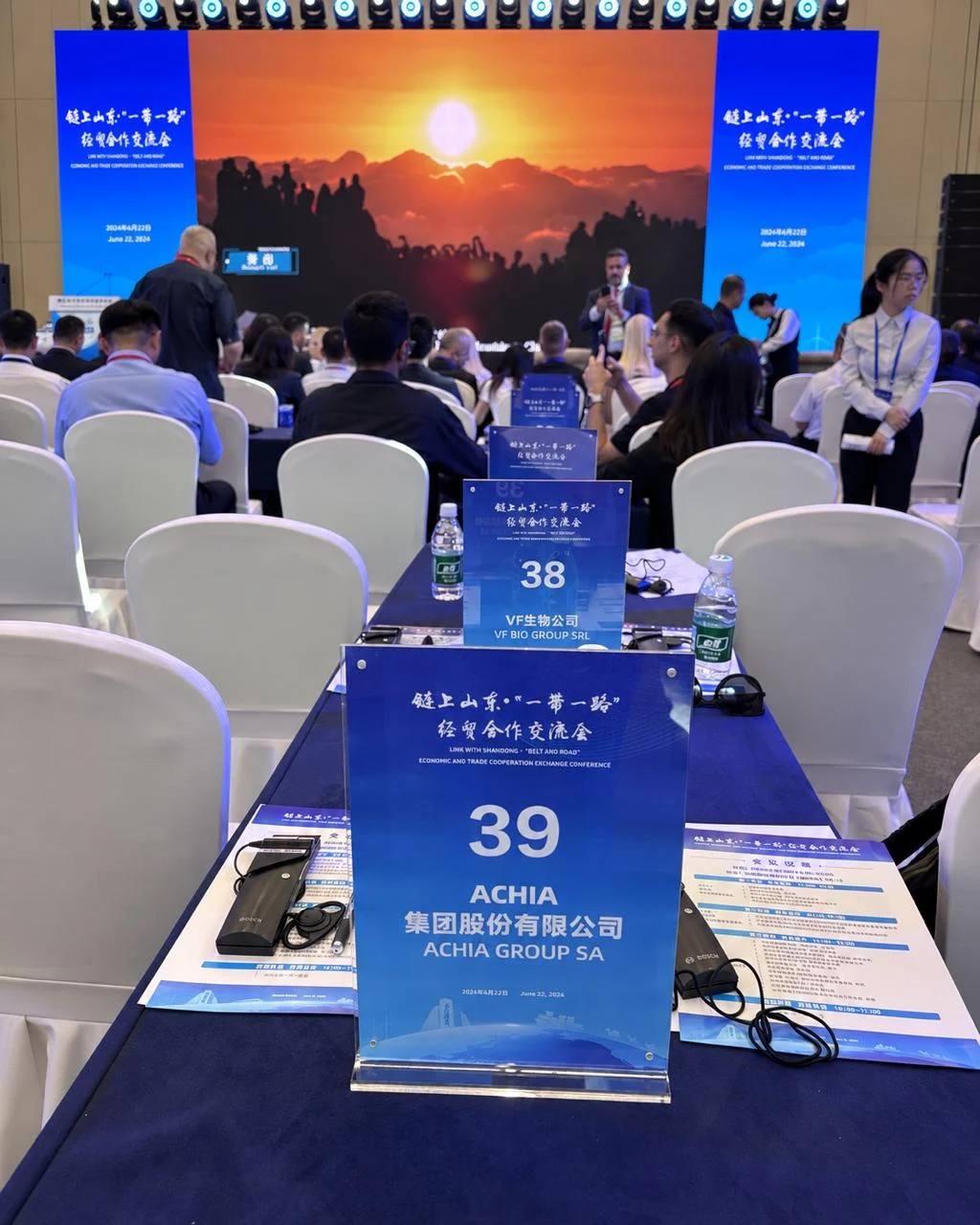ACHIA GROUP SA sign on table 39 in the hall.